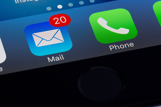 Email app icon on phone with notification of 20 unread emails